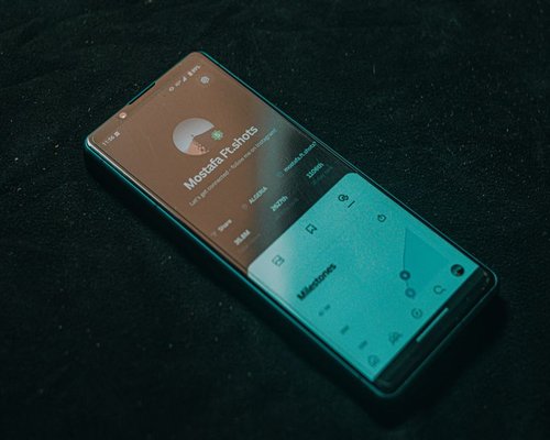 Smartphone displaying a fictional UI design at an exhibition