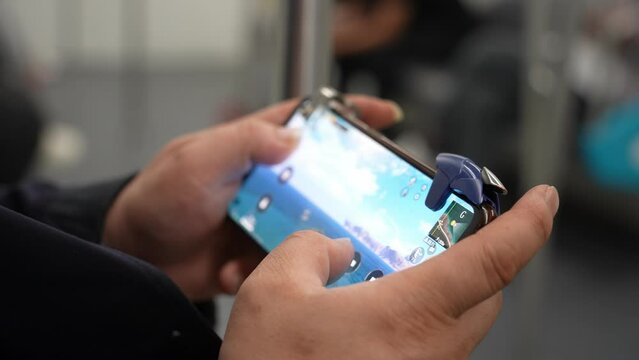 Smartphone displaying a fictional mobile game at an Australian gaming technology exhibition